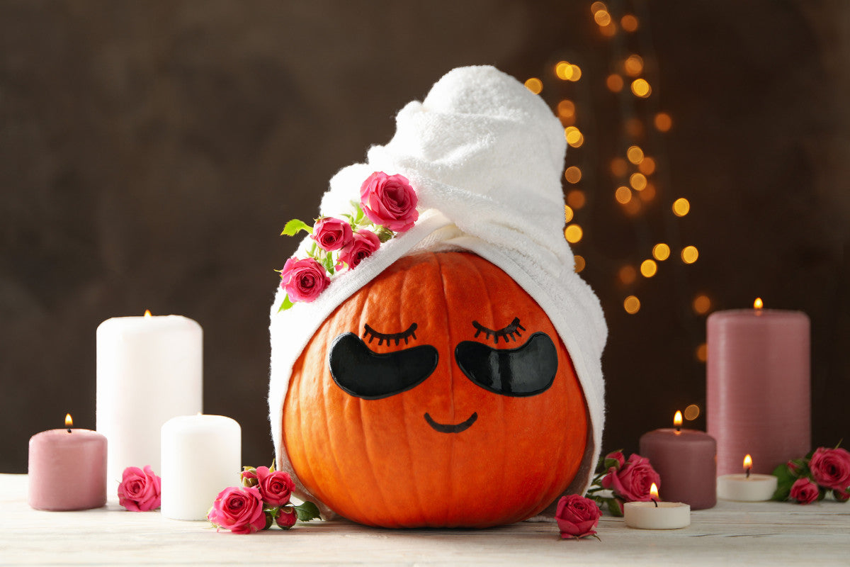 Candles and Pumpkin with Skincare Under-Eye Patches on Brown Background