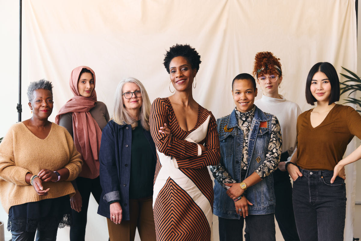 group of women standing together, smiling at the camera