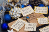 cards containing New Year's resolutions on them, surrounded by blue and white Christmas ornaments