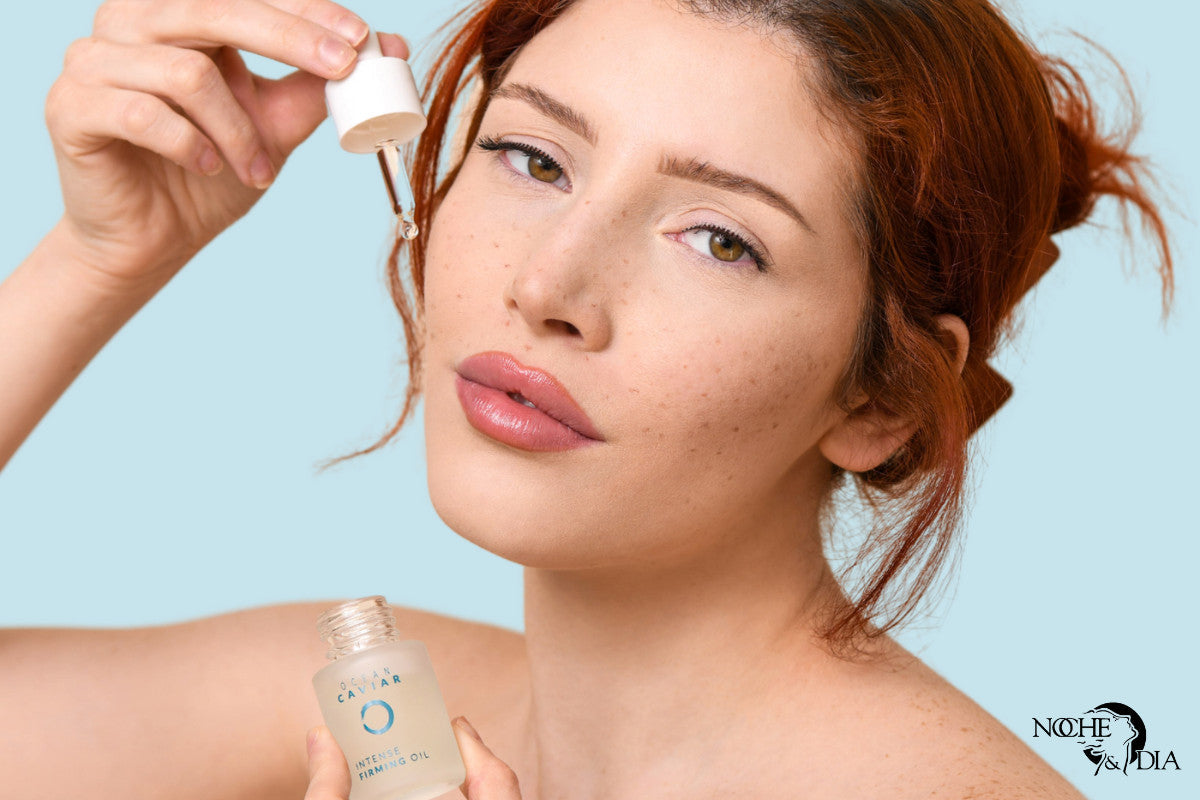 young woman holding up Noche's Caviar Firming Oil and using it on her face