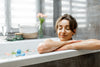 woman enjoying relaxing soak in bathtub