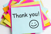 bright pink, yellow, and pale blue sticky notes stacked on top of one another. the words 