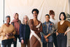 group of women standing together, smiling at the camera